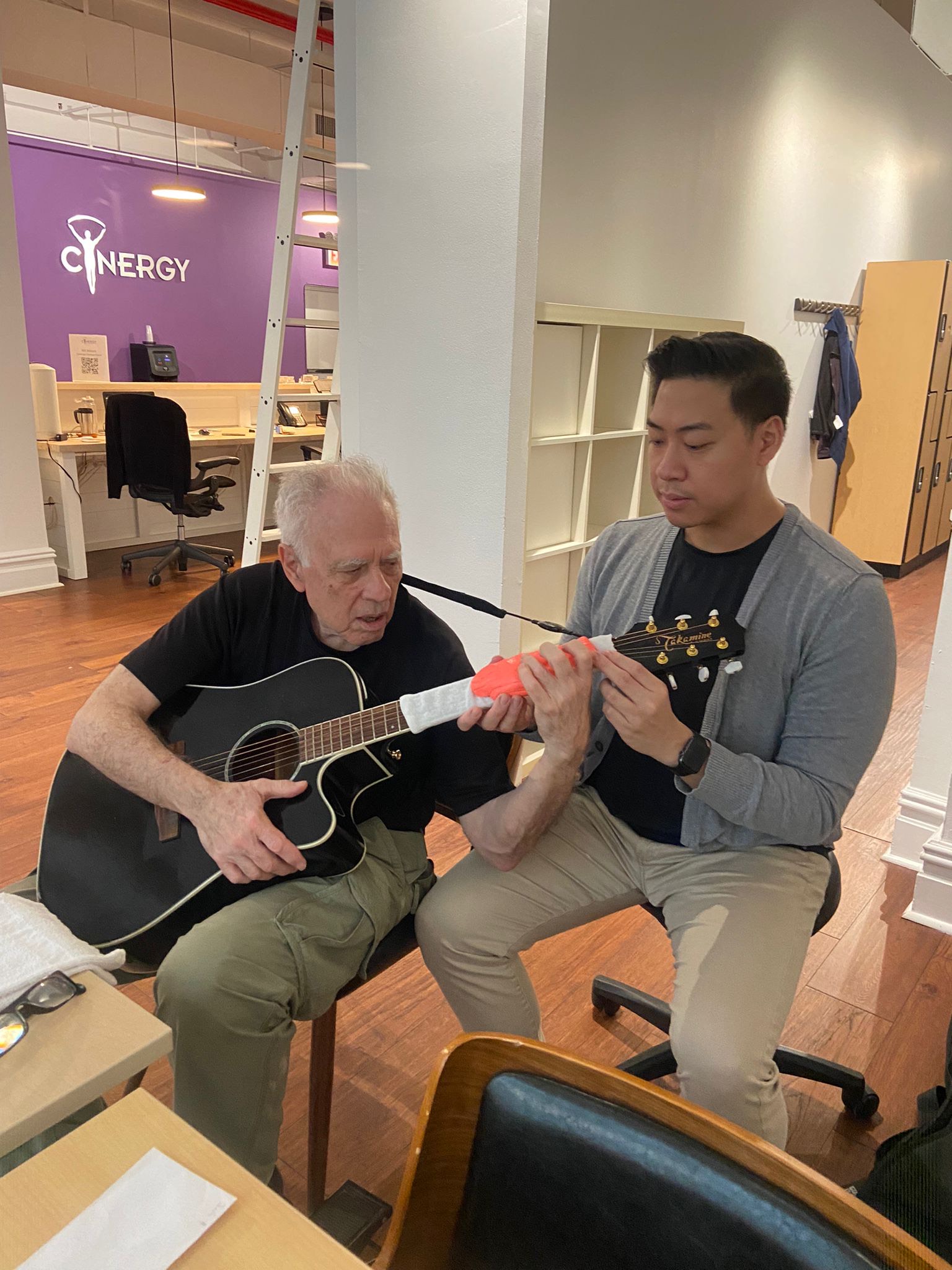 Andy and his patient working on his use of the guitar