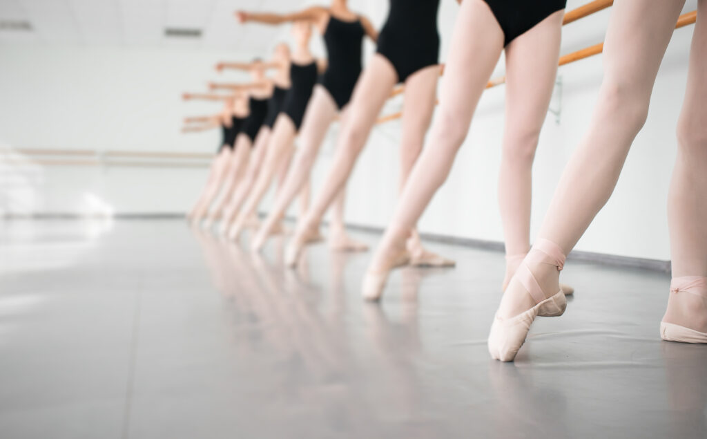 A row of ballerinas preparing to dance
