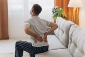 Man experiencing back pain in New York City, NY